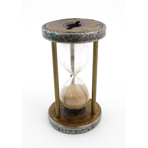 1111 - An early 20thC sand / egg timer with metal mounts. Approx. 6 1/4