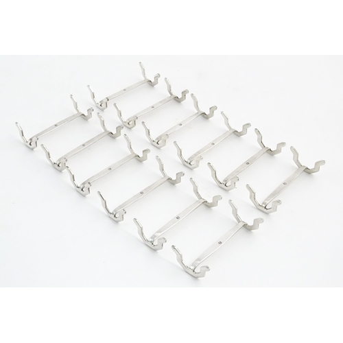 1113 - A set of twelve silver plate knife rests. Approx. 2 1/2