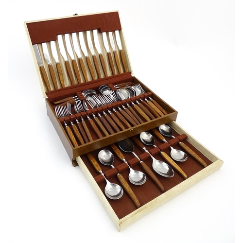 1115 - A vintage / retro Glosswood of Sheffield canteen of teak handled cutlery, comprising knives, forks a... 