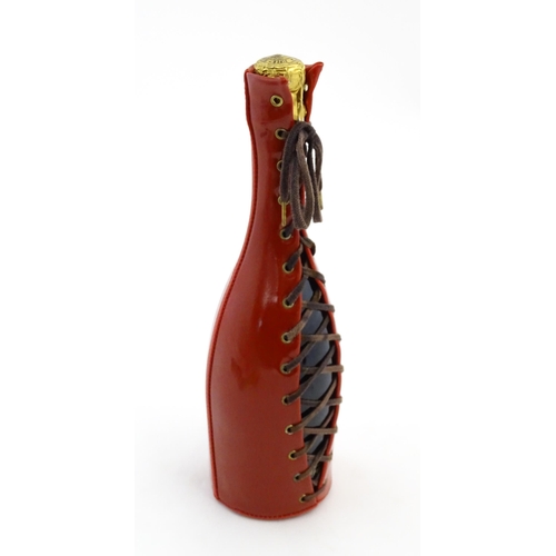 1123 - A 1999 limited edition 75cl bottle of Piper-Heidsieck champagne in a Jean-Paul Gaultier red PVC cors... 