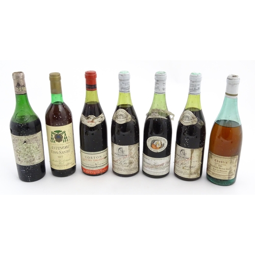 1129 - Seven bottles of vintage red wine, comprising a 1966 75cl bottle of Chateau Haut-Brion, two 1969 75c... 