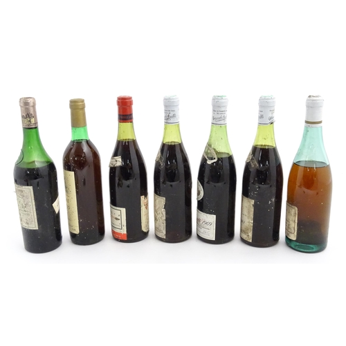 1129 - Seven bottles of vintage red wine, comprising a 1966 75cl bottle of Chateau Haut-Brion, two 1969 75c... 