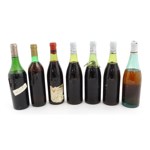 1129 - Seven bottles of vintage red wine, comprising a 1966 75cl bottle of Chateau Haut-Brion, two 1969 75c... 