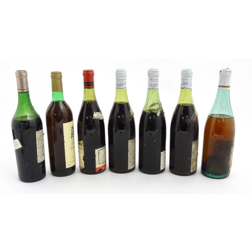 1129 - Seven bottles of vintage red wine, comprising a 1966 75cl bottle of Chateau Haut-Brion, two 1969 75c... 