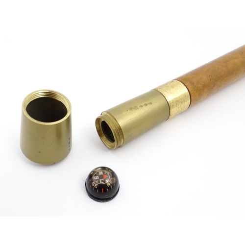 1277 - A late 20thC novelty combination walking stick / cane with compass and flask. Approx. 36 1/4