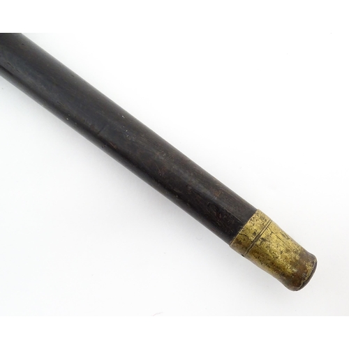 1278 - A 19thC ebonised walking stick / cane with yellow metal top bearing heraldic coat of arms and motto ... 