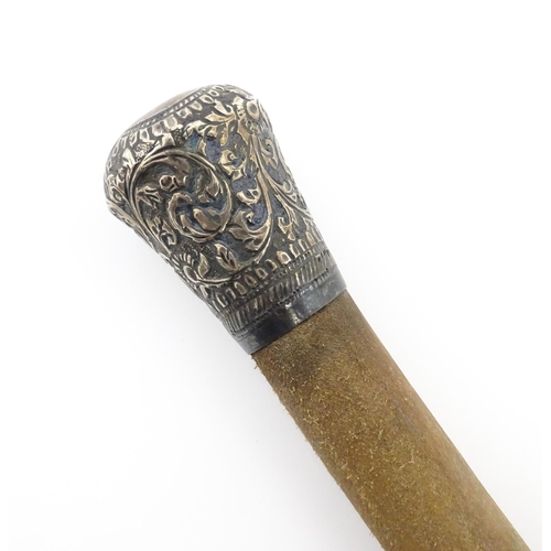 1279 - An early 20thC bull pizzle walking stick / cane with white metal pommel, possibly Indian. Approx. 34... 