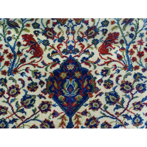 1387 - Carpet / Rug : A Grosvenor Wilton carpet with cream ground rug with central vignette with scrolling ... 