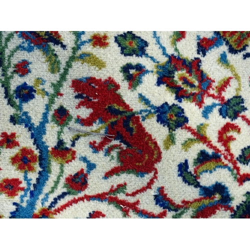 1388 - Carpet / Rug : A Grosvenor Wilton carpet with cream ground rug with central vignette with scrolling ... 