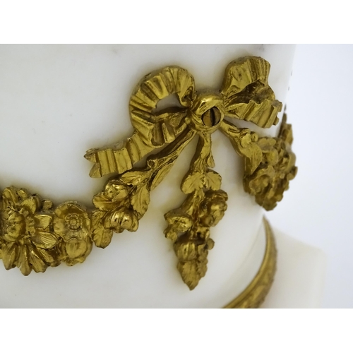 1396 - A late 19thC French white marble ormolu clock garniture, the clock formed as three ormolu putti hold... 