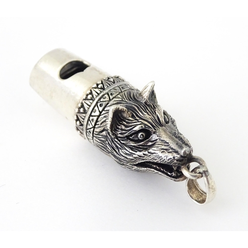 411 - A novelty white metal whistle with fox head decoration. Approx. 1 1/2