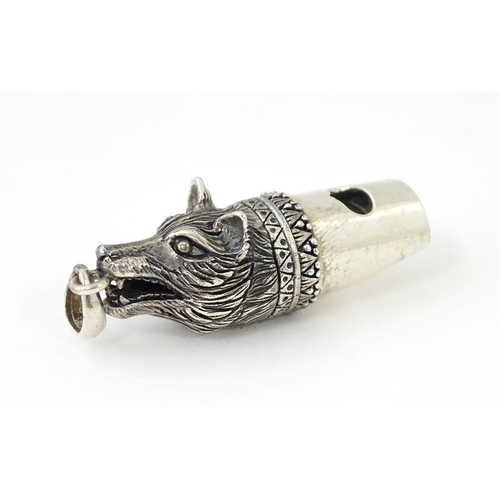 411 - A novelty white metal whistle with fox head decoration. Approx. 1 1/2