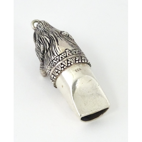 411 - A novelty white metal whistle with fox head decoration. Approx. 1 1/2