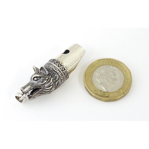 411 - A novelty white metal whistle with fox head decoration. Approx. 1 1/2