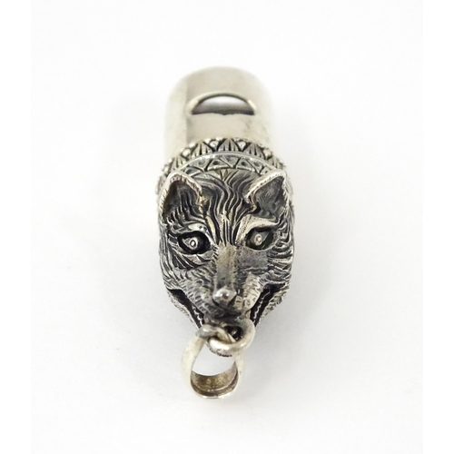 411 - A novelty white metal whistle with fox head decoration. Approx. 1 1/2