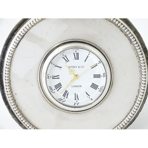 414 - A small easel back desk clock of circular form with silver surround hallmarked London 2000, maker Ki... 