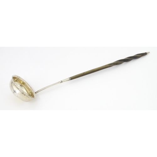 418 - A white metal punch ladle with coin style detail to bowl. Approx. 13