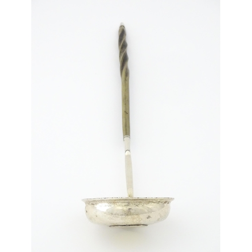 418 - A white metal punch ladle with coin style detail to bowl. Approx. 13