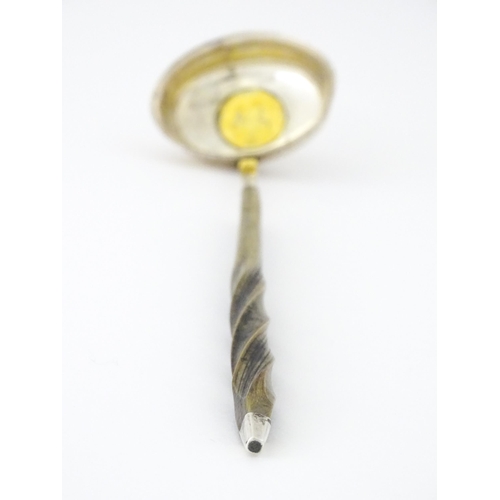 418 - A white metal punch ladle with coin style detail to bowl. Approx. 13