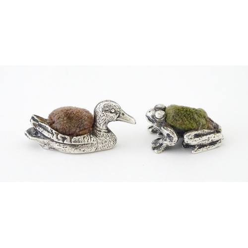 424 - Four white metal novelty pin cushions comprising frog, duck and two teddy bears. Duck approx. 1 1/4