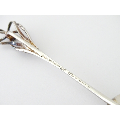 428 - An Australian .925 silver teaspoon the handle surmounted by a spider orchid, maker Harris & Sons of ... 