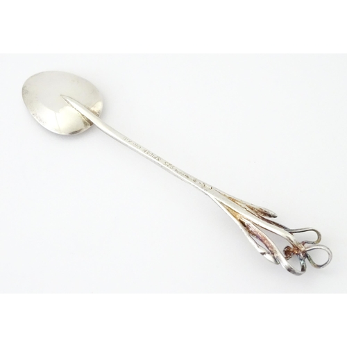 428 - An Australian .925 silver teaspoon the handle surmounted by a spider orchid, maker Harris & Sons of ... 