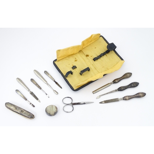 440 - A quantity of silver manicure tools etc within a leather case having engine turned decoration and ha... 