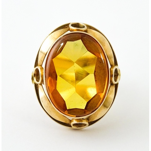 618 - A yellow metal cocktail ring set with central orange citrine. Ring size approx. N 1/2