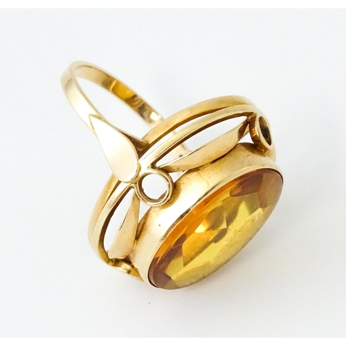 618 - A yellow metal cocktail ring set with central orange citrine. Ring size approx. N 1/2