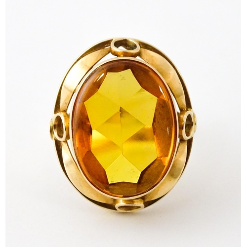 618 - A yellow metal cocktail ring set with central orange citrine. Ring size approx. N 1/2