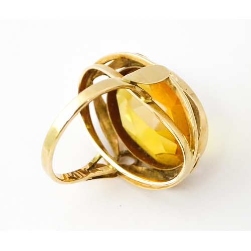 618 - A yellow metal cocktail ring set with central orange citrine. Ring size approx. N 1/2