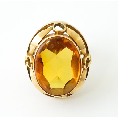 618 - A yellow metal cocktail ring set with central orange citrine. Ring size approx. N 1/2