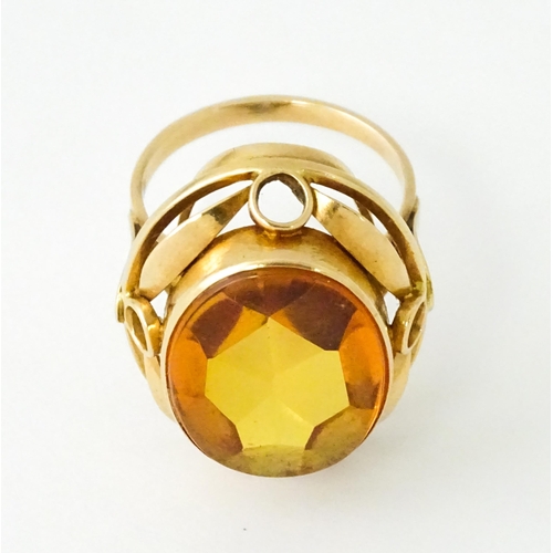 618 - A yellow metal cocktail ring set with central orange citrine. Ring size approx. N 1/2