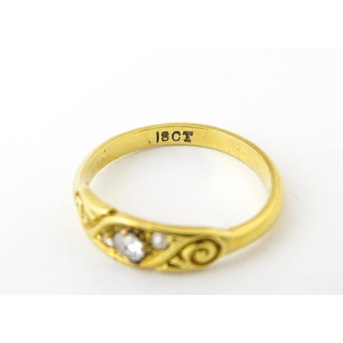 619 - An 18ct gold ring set with three diamonds. Ring size approx. I 1/2