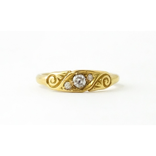 619 - An 18ct gold ring set with three diamonds. Ring size approx. I 1/2