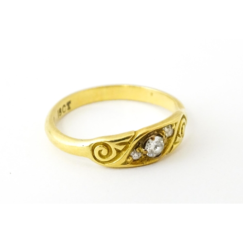 619 - An 18ct gold ring set with three diamonds. Ring size approx. I 1/2