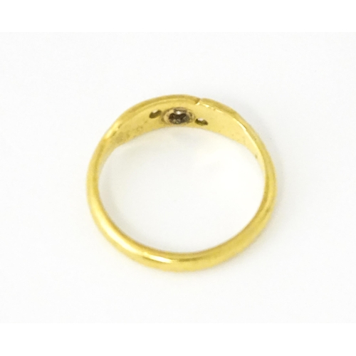 619 - An 18ct gold ring set with three diamonds. Ring size approx. I 1/2