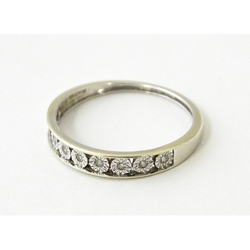 623 - A 9ct gold ring set with diamonds in a linear setting. Ring size approx. P