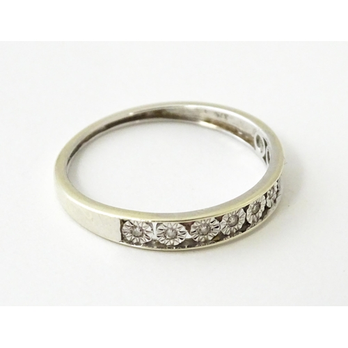 623 - A 9ct gold ring set with diamonds in a linear setting. Ring size approx. P