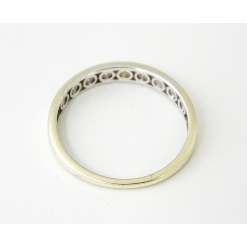 623 - A 9ct gold ring set with diamonds in a linear setting. Ring size approx. P