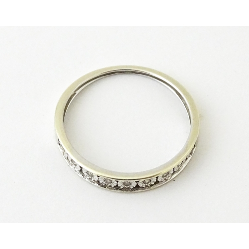 623 - A 9ct gold ring set with diamonds in a linear setting. Ring size approx. P