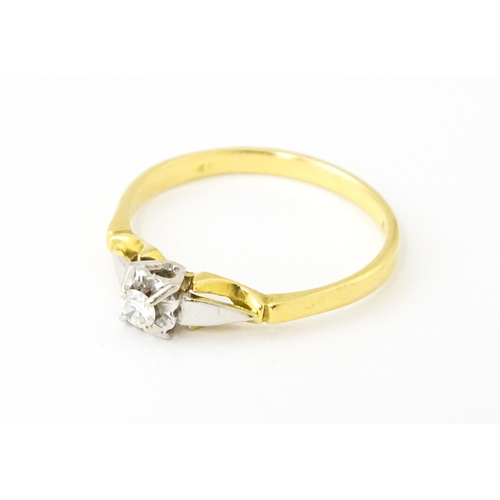 628 - An 18ct gold ring set with central diamond solitaire. Ring size approx. T 1/2