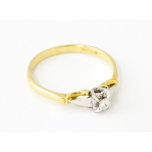 628 - An 18ct gold ring set with central diamond solitaire. Ring size approx. T 1/2