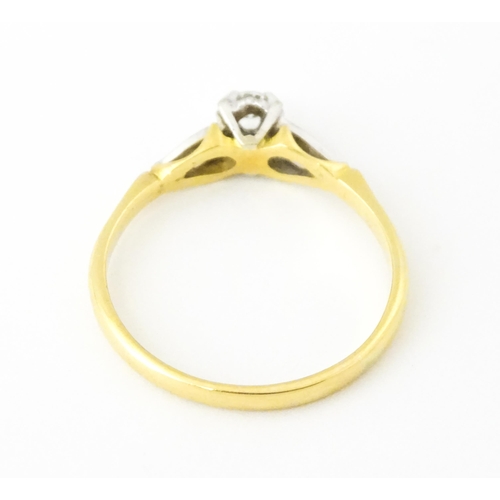 628 - An 18ct gold ring set with central diamond solitaire. Ring size approx. T 1/2