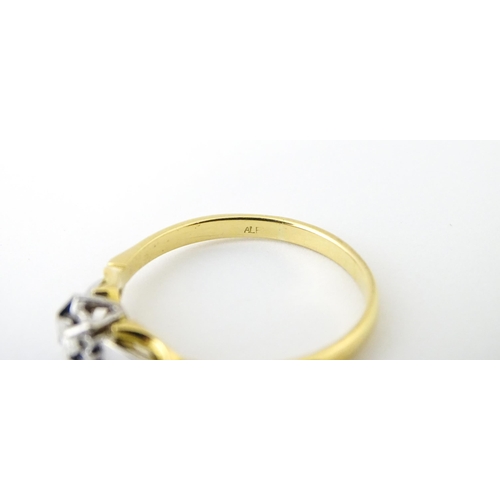 628 - An 18ct gold ring set with central diamond solitaire. Ring size approx. T 1/2