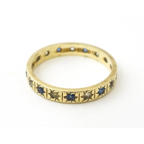 632 - A 9ct gold ring set with blue and white stones. Ring size approx. N