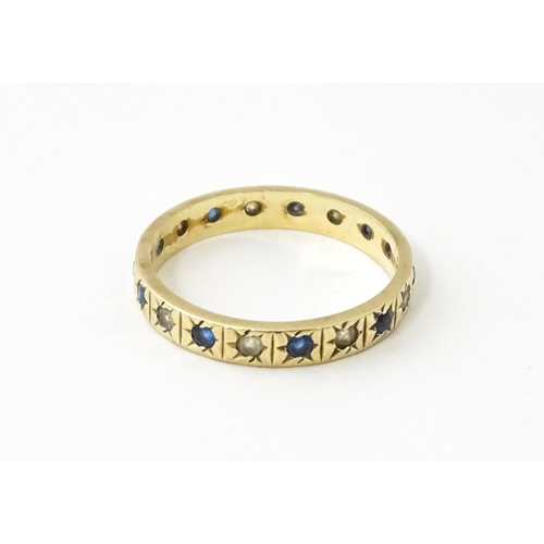 632 - A 9ct gold ring set with blue and white stones. Ring size approx. N