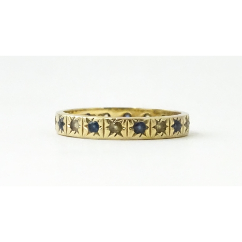 632 - A 9ct gold ring set with blue and white stones. Ring size approx. N