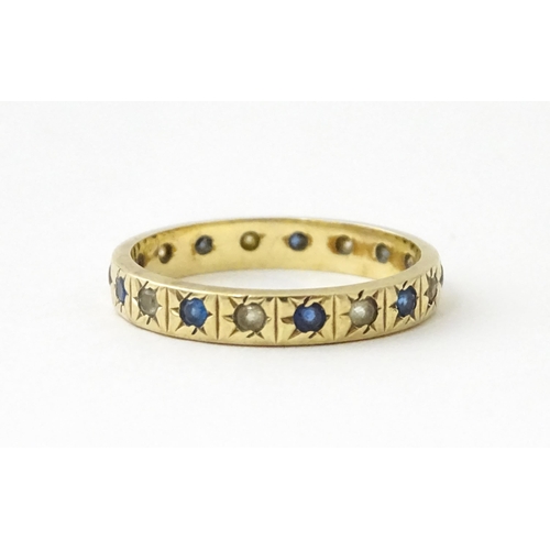 632 - A 9ct gold ring set with blue and white stones. Ring size approx. N