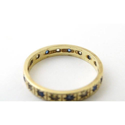 632 - A 9ct gold ring set with blue and white stones. Ring size approx. N